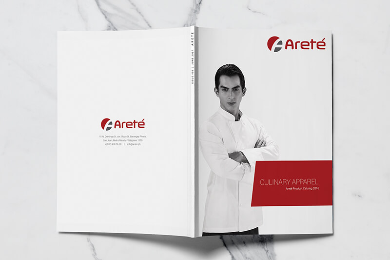 A photo of an open magazine showing the front and back cover against a white marble background.