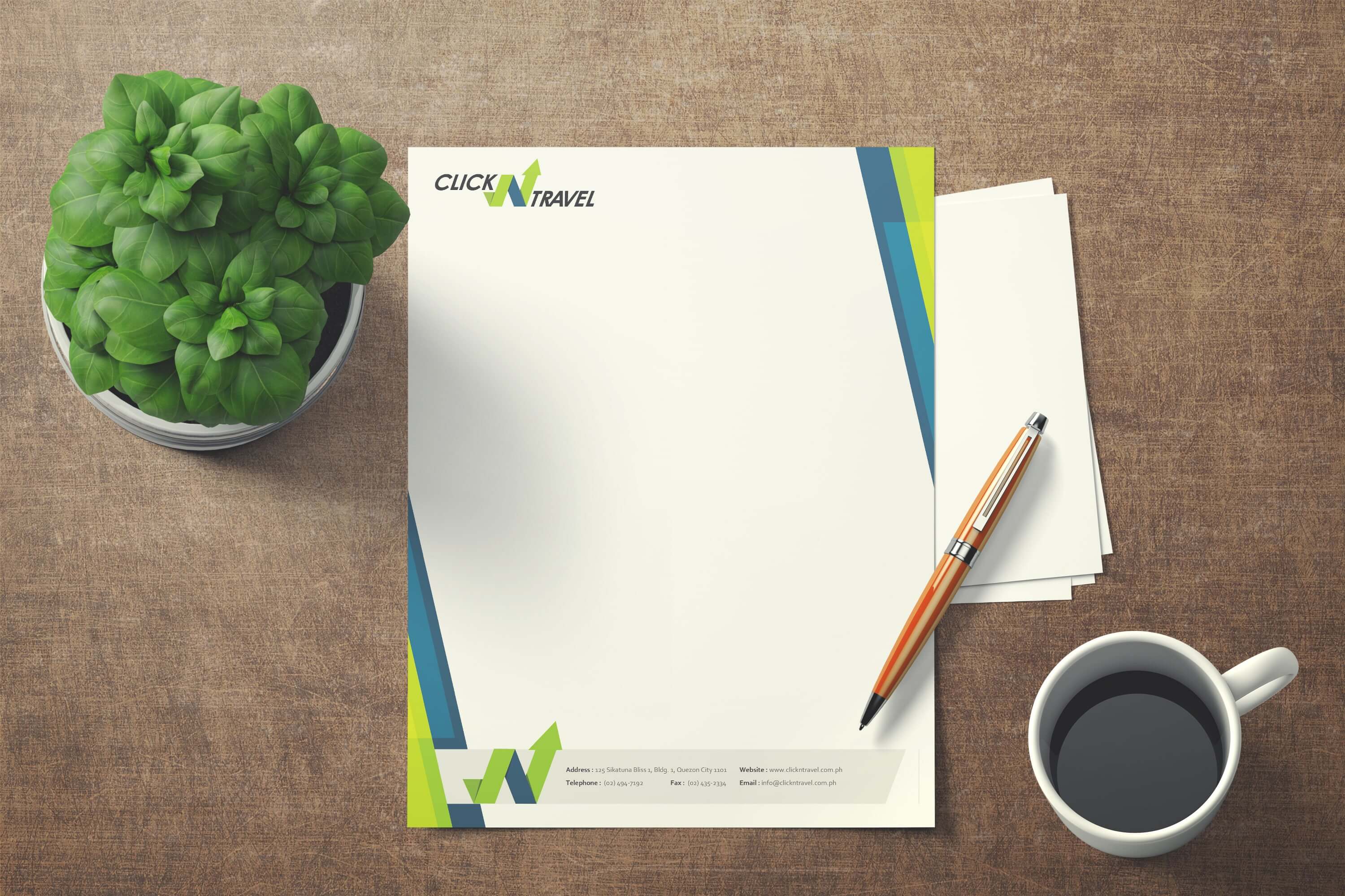 A Click N Travel branded letterhead is laid on a desk, next to a potted plant, a pen, and a cup of coffee.