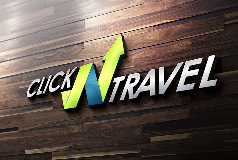 The logo for Click N Travel mounted on a dark wooden wall, featuring a green and blue N shaped like an upward arrow.