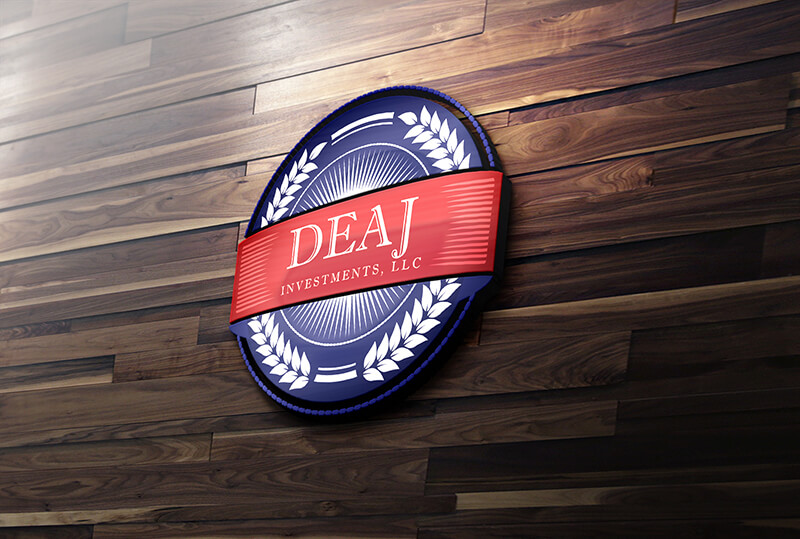The circular logo for DEAJ Investments, LLC, featuring blue and red elements, is mounted on a wooden wall.