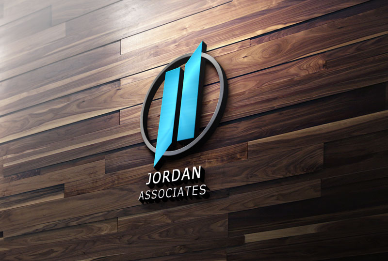 A 3D wall mockup features the Jordan Associates logo mounted on a dark brown wooden plank wall.