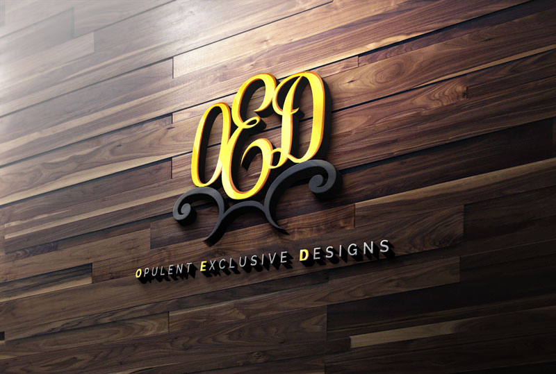 The OED logo for Opulent Exclusive Designs, featuring gold lettering and black flourishes, mounted on a dark wood panel wall.