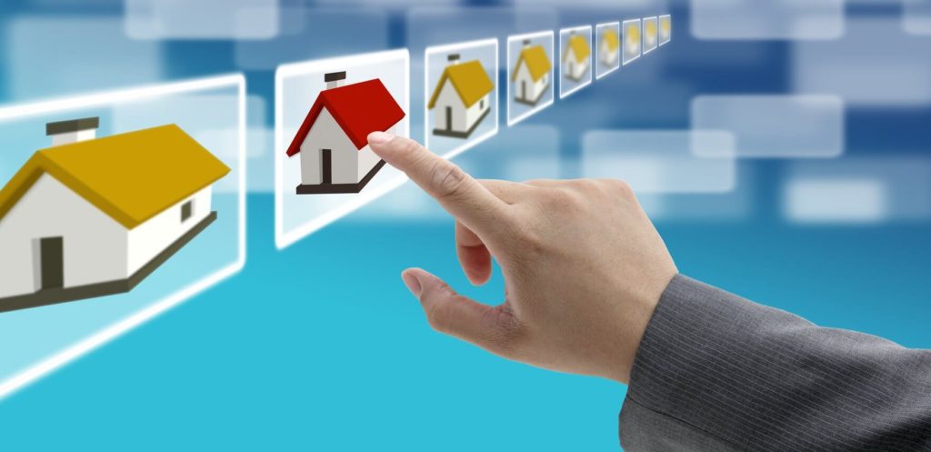 A hand points to a digital icon of a house with a red roof within a row of virtual real estate listings against a blue background.
