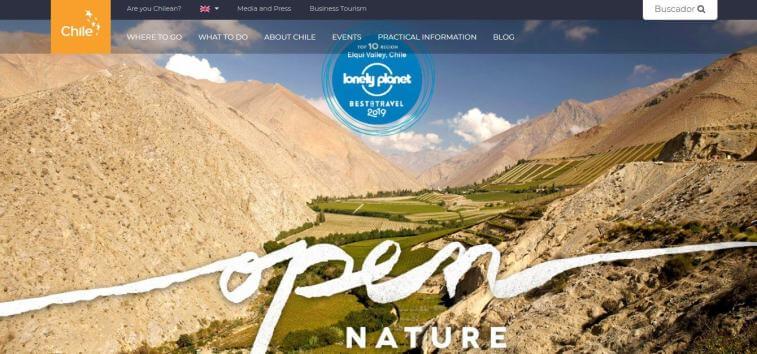 A screenshot of the Chile tourism website with a panoramic view of the Elqui Valley, featuring dry mountains, a green valley, a Lonely Planet Best in Travel 2019 badge, and the text "open NATURE".
