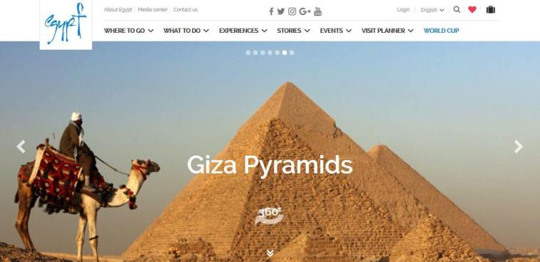 A website screenshot of the Egypt Tourism homepage displaying a person riding a camel in front of the Giza Pyramids.