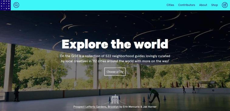 A screenshot of the "On the Grid" website homepage featuring the headline "Explore the world" over an outdoor skating rink surrounded by trees.