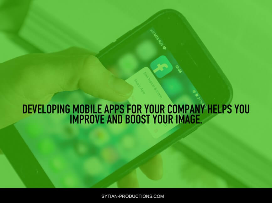 A hand holds a smartphone displaying app icons with the text developing mobile apps for your company helps you improve and boost your image.