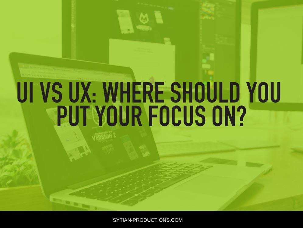 A graphic with a green tint overlays a laptop and monitors, with bold text reading "UI VS UX: WHERE SHOULD YOU PUT YOUR FOCUS ON?".