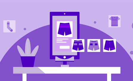 A purple-themed illustration of an e-commerce landing page on a monitor, displaying apparel products like shorts and shirts, placed on a desk with a potted plant.