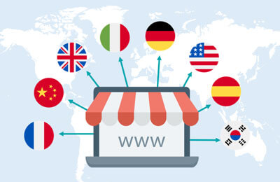 An online store icon on a laptop with arrows pointing to country flags representing a multi-lingual website.
